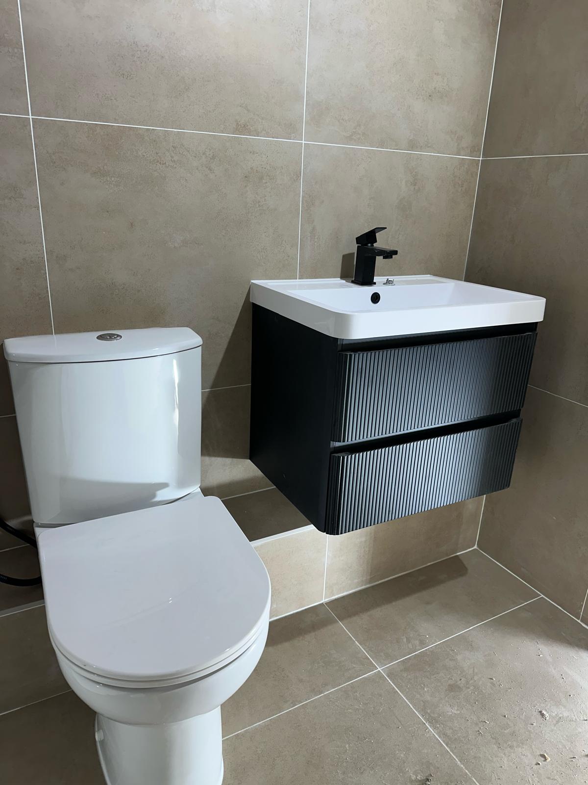 Completed bathroom with a fluted vanity unit