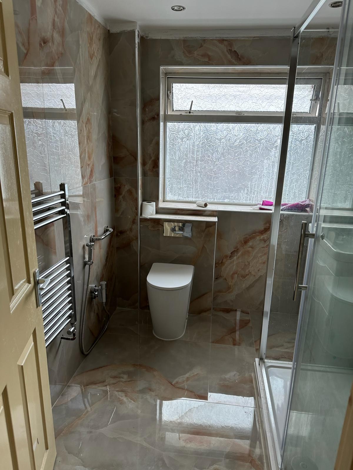 Completed dark stone en-suite shower room