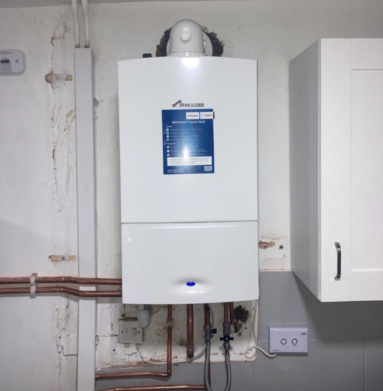 Boiler installation with neatly finished copper pipework by M&F