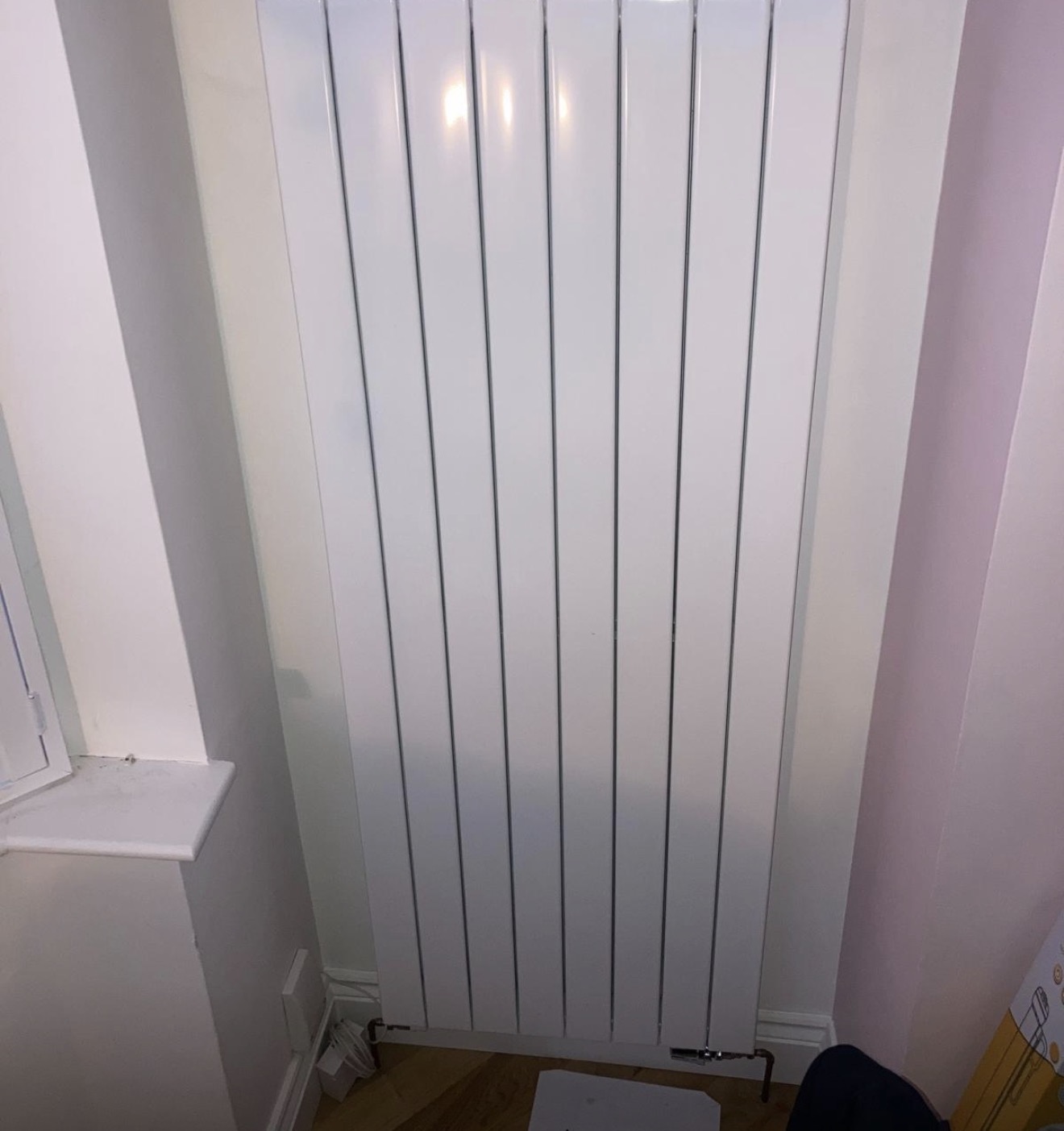 Designer vertical radiator installed by M&F