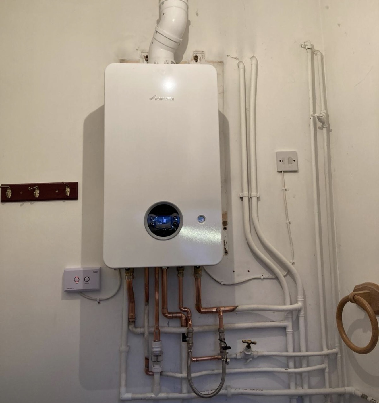 Wall-hung boiler with neatly clipped pipework